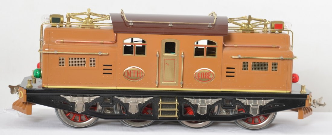 MTH Tinplate 408E brown electric locomotive: MTH modern standard gauge tinplate 10-1229-1 No. 408E two tone brown electric locomotive. Loco is the traditional version and is C8 with run time. Loco has inner carton but no box.