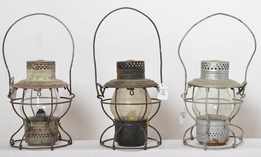 3 Handlan lanterns New York Central MoPac: Three Handlan clear globe lanterns. Includes New York Central with black painted body, silver painted New York Central missing burner parts, and MoPac with flaking white paint. All three have railroad