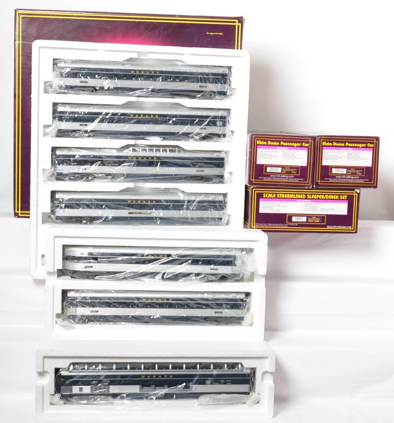 MTH Wabash 9 car passenger set: MTH modern O gauge Wabash nine car passenger set in OBs. Includes 20-6546 five car set, 20-6646 diner / sleeper add on without the box, and two 20-6746 full vista domes. Cars are C8 with run time. OBs
