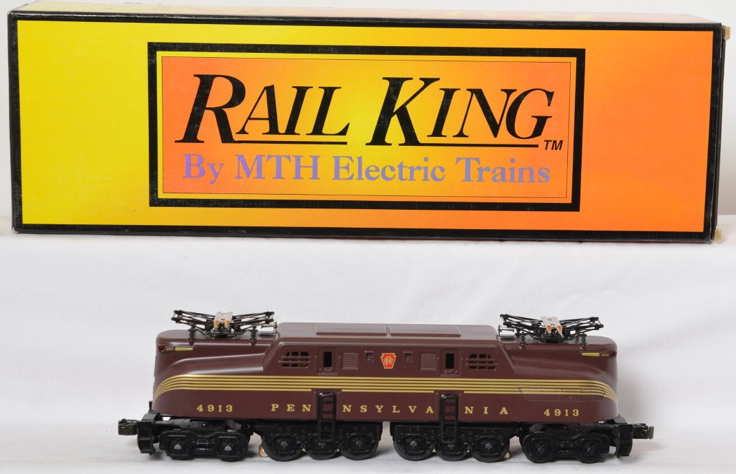 Railking Pennsylvania tuscan GG1: MTH Railking modern O gauge RK-2501 Pennsylvania Tuscan five stripe GG-1 in OB. Loco features horn, can motors, and more. C8 with run time. OB has some very light corner wear.