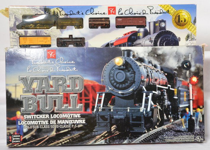 2 Presidents Choice Canadian HO sets CP, CN: Presidents Choice modern HO Canadian train sets in OBs. Includes Canadian National Yard Bull set with one tape repaired flap on the box and Canadian Pacific 2-6-0 Camel Back express/ Sets are C9-10.