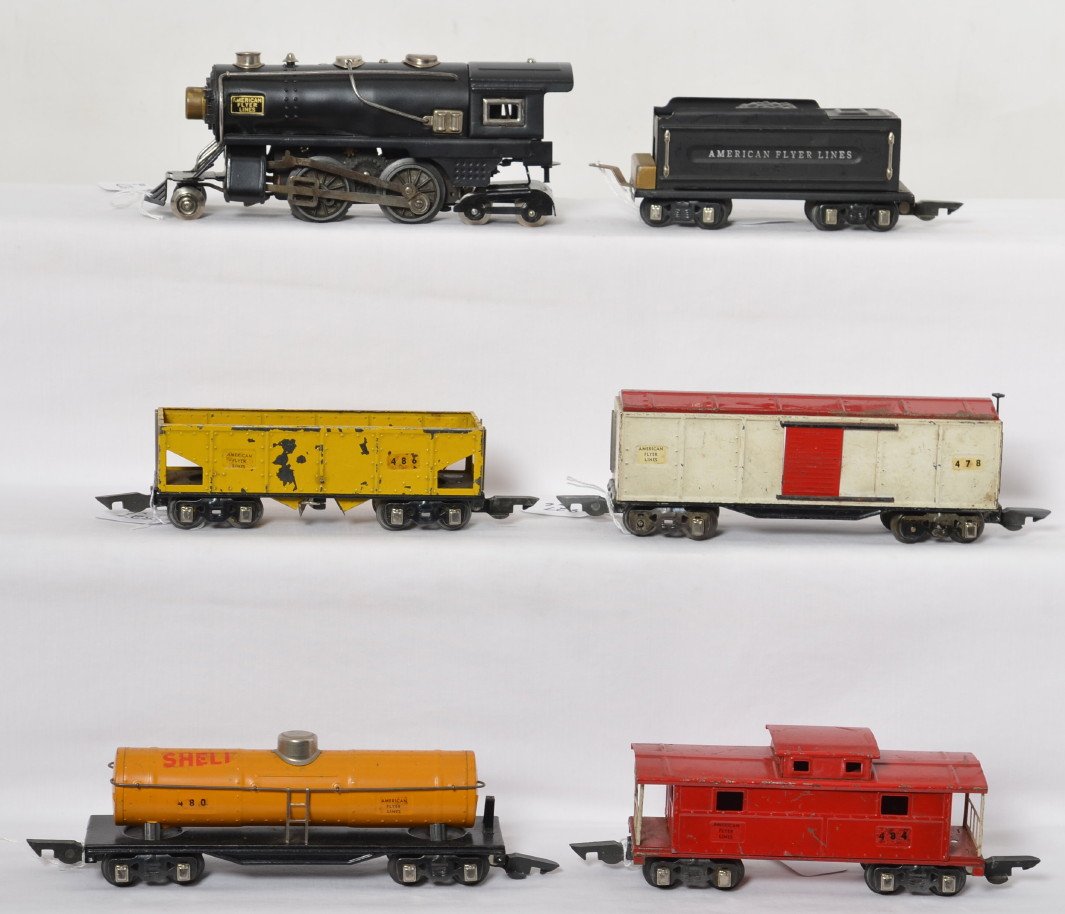 American Flyer 3/16î scale O gauge steam freight: Prewar American Flyer O/narrow gauge 3/16î scale steam locomotive and tender with 480 Shell tank car, 486 hopper, 478 boxcar, and 484 caboose. Loco and tender are repainted, C6-7. Rest of trains look