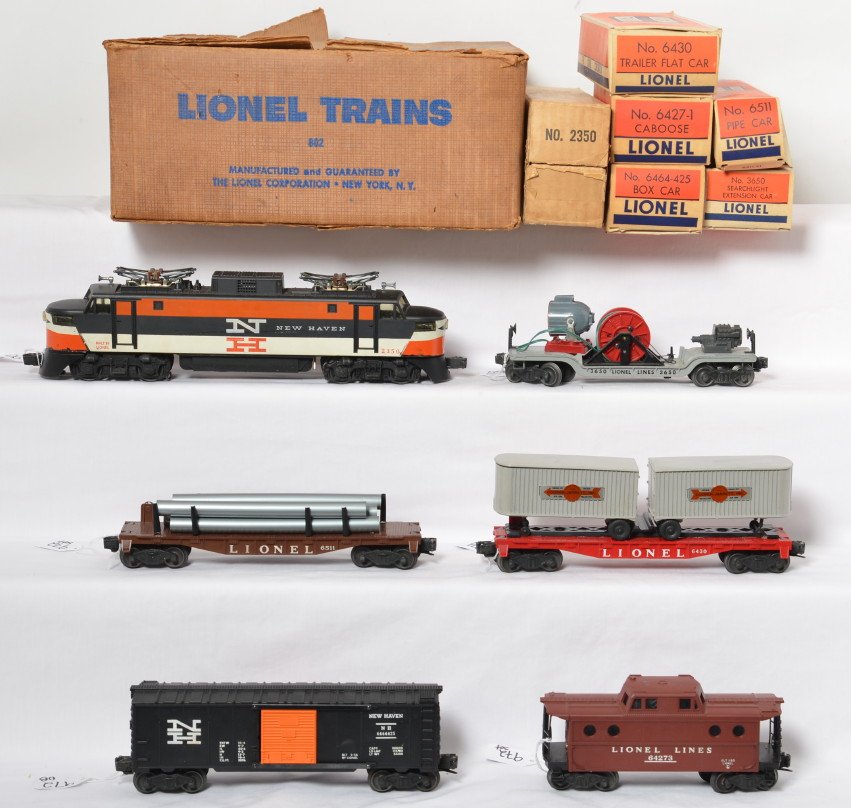 Lionel boxed 802 set with 2350 New Haven: Lionel postwar O gauge boxed set 802 with a complete but darkened set box. The set includes a 2350 New Haven electric with decal nose C7, 3650 searchlight car C6-7, 6430 flat with trailers C7-8, 6511 