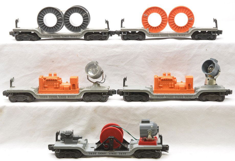 Lionel Freight Cars 3650 6520 3520 6561 6561: Lionel postwar freight cars 3650 searchlight with reel, 6520 searchlight, 3520 searchlight, two 6561 flatcars with reels. The 3620 is missing the lens cover, 3650 is missing the crank and the 6561 has