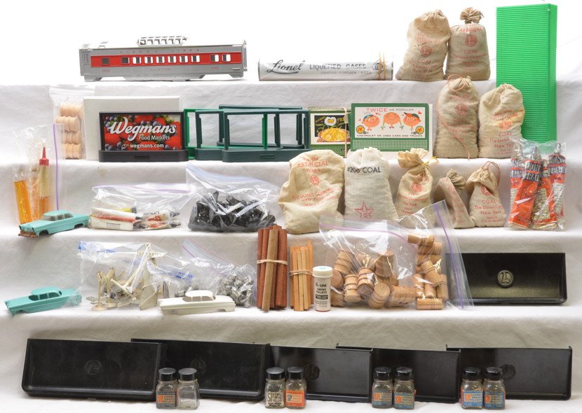 Lionel Selection of Postwar Parts and Accessories: Lionel selection of postwar parts and accessories including; billboard frames, billboards, 160 bins, 2442 shell only, green roof, cattle, barrels, cars, logs, 6469 Erie Liquefied Gases reproduction ta