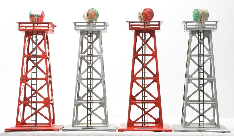 Lionel 2-Red 2-Silver 494 Rotating Beacons: Lionel postwar four 494 rotating beacons, two red and two silver. One of the silver beacons has green paint spray on the bottom base. The beacons are C6-7.