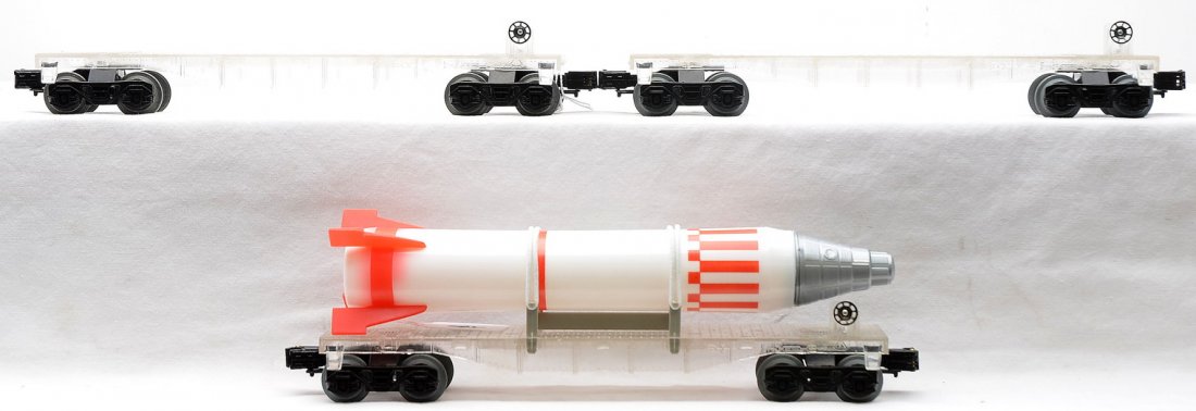 Model Train Sales 3-Clear Flatcars one w/Rocket: Model Train Sales Inc. made in Korea three clear flatcars, one with an unmarked rocket. The flatcars have never been painted. The cars have never been run, C9.