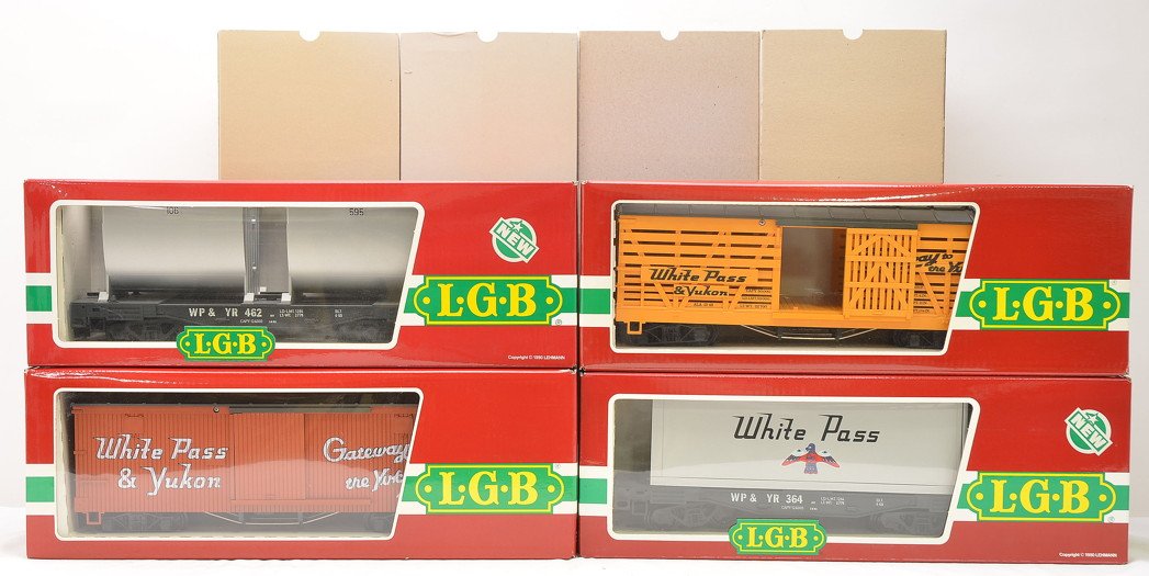 LGB White Pass Freights 4167 4168 4085 4086: LGB G scale White Pass & Yukon freight cars including; 4167 boxcar, 4168 stock car, 4085 flatcar with container and a 4086 flatcar with two containers all in OBs with outer sleeves. Cars have never be