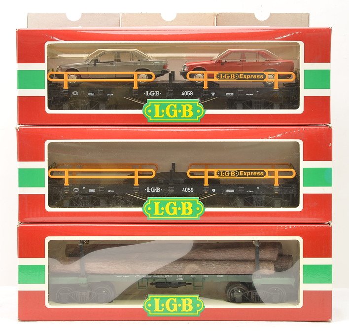 LGB 2-4059 Flatcars 1-w/Autos 4066 Log Loader: LGB G scale two 4059 flatcars one with two autos and one with no load and a 4066 log loader all in OBs with outer sleeves. Cars have never been run, C9-10.
