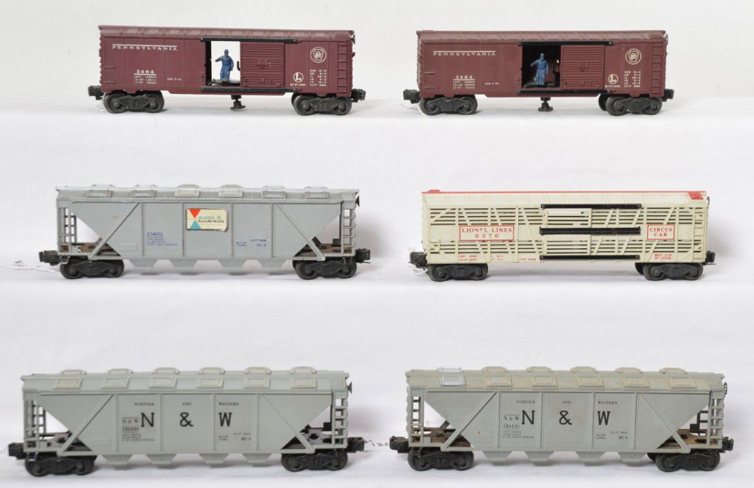 Lionel 3484, 3484, 6376, 6346, 6446, 6446: Postwar Lionel O gauge, two 3484 Pennsylvania operating boxcars, 6376 Circus car, 6346 Alcoa hopper, two 6446 N&W hoppers, C6. Some hopper hatches have been replaced.
