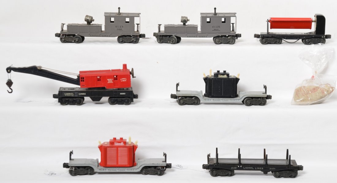 Lionel 2461, 2461, 3451, 3559, 6560, 2420, 6420 freight: Postwar Lionel O gauge freight cars, two 2461 transformer cars, 3451 log car, 3559 ore dumping car, 6560 operating work crane, 2420 searchlight caboose, and 6420 searchlight caboose. 2420 has hairline