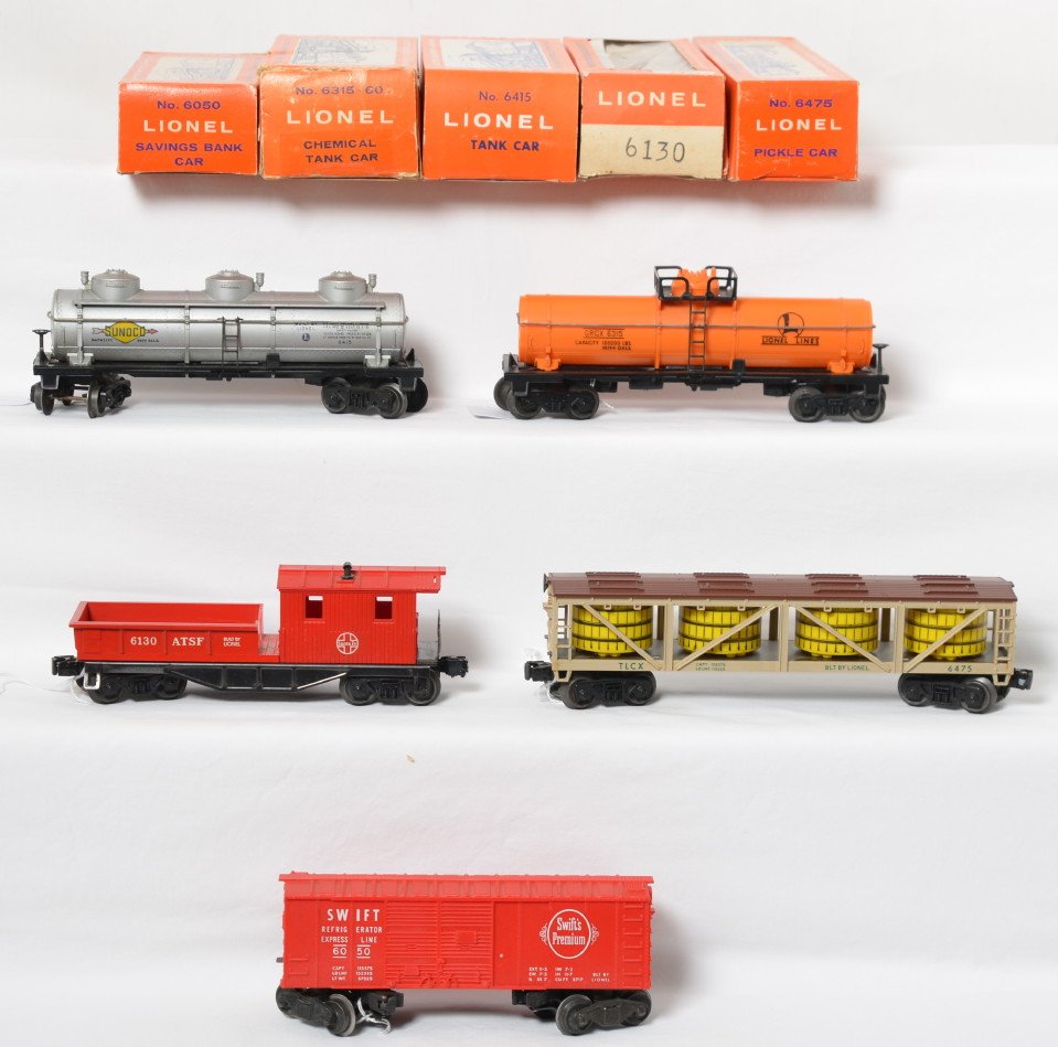 Lionel 6315-60, 6415, 6130, 6475, 6050 in OB: Postwar Lionel O gauge 6315-60 chemical tank, 6415 Sunoco tank, 6130 Santa Fe work caboose, 6475 pickle vat car, and 6050 Swift Premium reefer, C7-8. 6050 OB has a missing tuck flap, 6315-60 has wear 