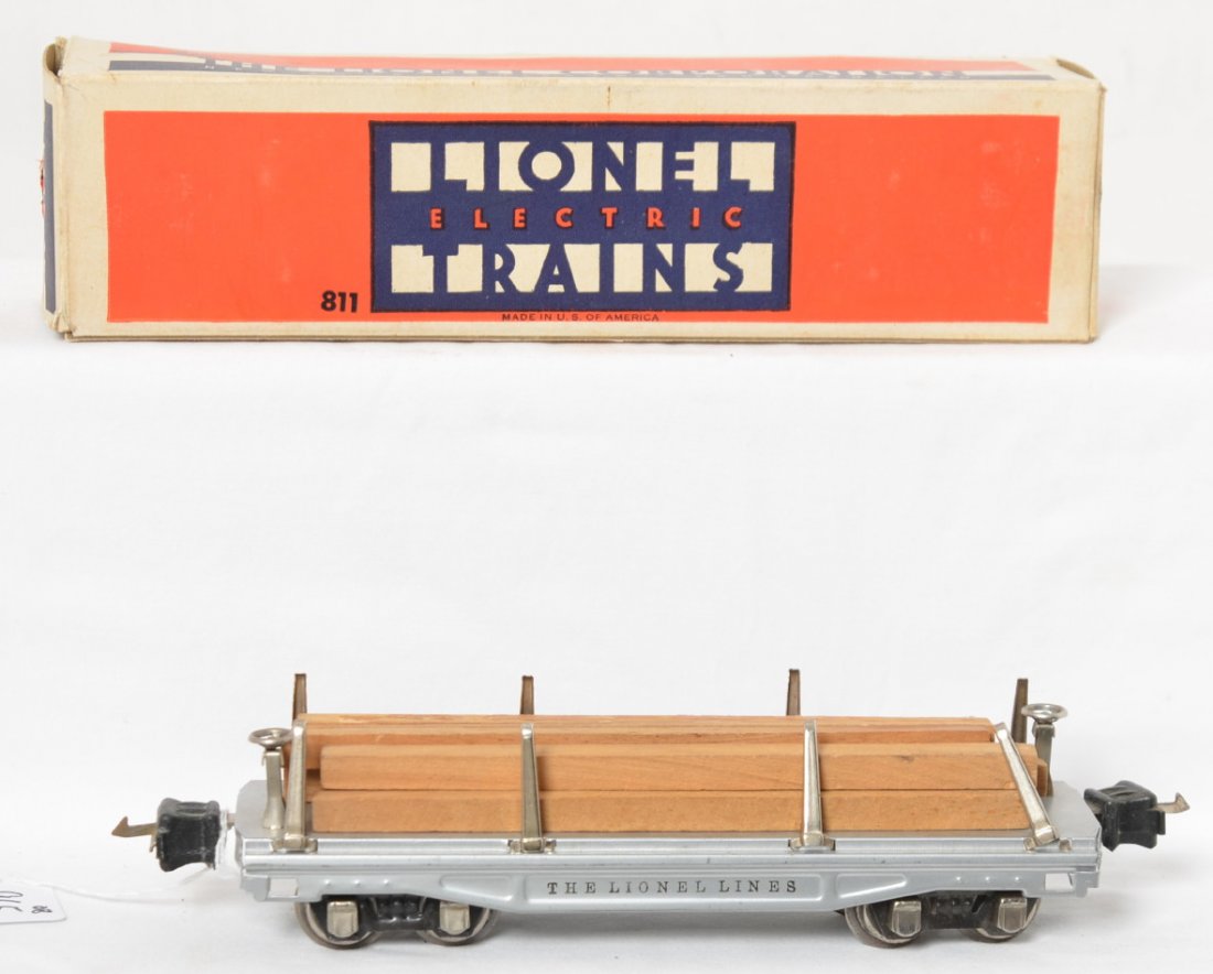 Lionel 811 silver lumber car in OB w/timbers: Prewar Lionel O gauge No. 811 lumber car with timbers, silver in original box, C7. Box has missing inner coupler protection flaps, small punctures in flaps, and one detached but included inner flap. B