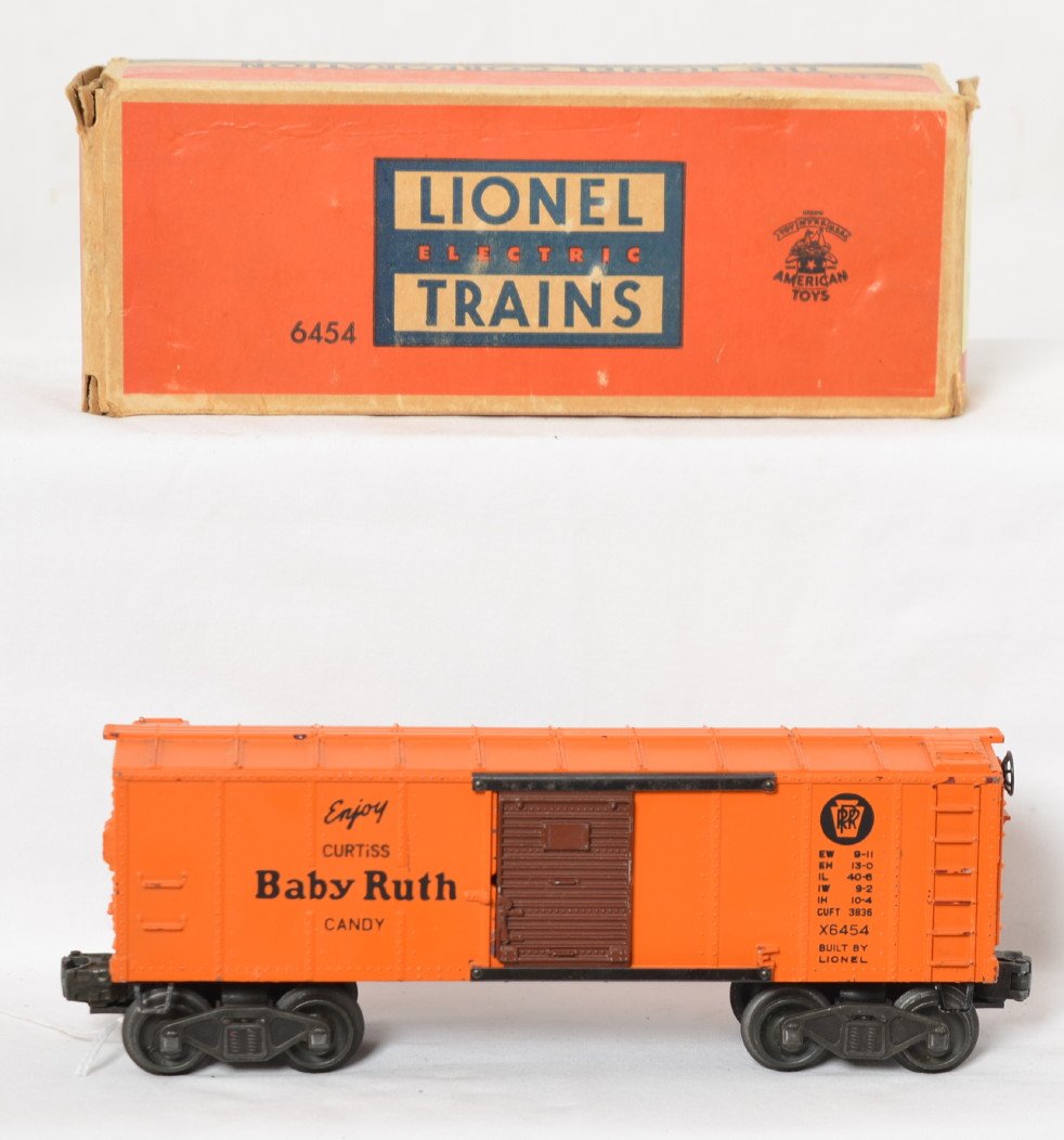 Lionel X6454 Pennsylvania Baby Ruth boxcar in OB: Postwar Lionel O gauge X6454 Pennsylvania Baby Ruth boxcar in original box, tiny nick to a ladder step, otherwise C6+. Box has tears to several flaps, otherwise square and solid.