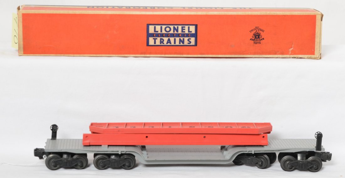 Lionel 6418 machinery car with spans in OB w/inserts: Postwar Lionel O gauge 6418 machinery car in original box with bridge spans, original load restraints, and inserts, C7. Box has scuffing to a corner with some creasing. Box is very square and solid wi