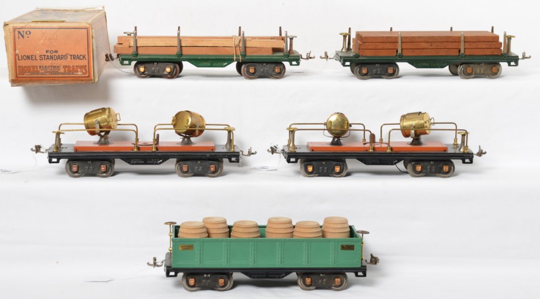 Lionel 511, 511, 512, 520, 520 w/one 520 OB: Prewar Lionel standard gauge freight cars with one original box. Two 511 flatcars with lumber/timbers, 512 gondola with six wooden barrels. Trains have some light surface rust and oxidation here and t