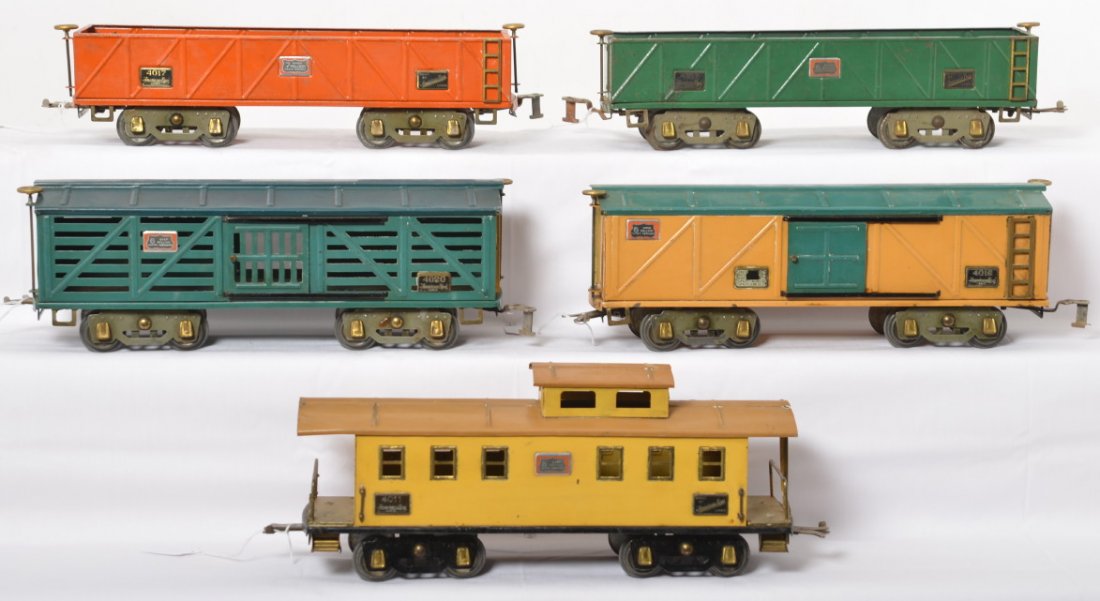 American Flyer 4011, 4017, 4017, 4018, 4020 freight: Prewar American Flyer wide gauge freight cars, 4011 caboose, two 4017 sand cars, 4018 boxcar, and 4020 stockcar. Caboose is missing smoke stack, O/W trains look C6+ area.