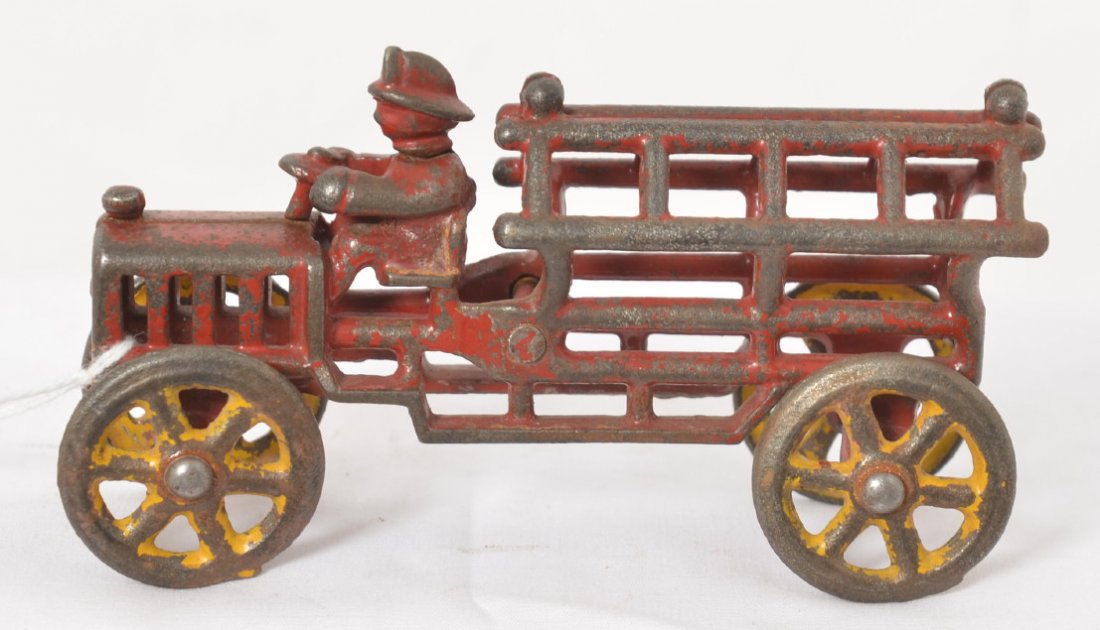Very early cast iron fireman ladder truck w/driver: Very early cast iron fireman ladder truck with driver and steel wheels. 5-1/4 inches long. Appears completely original.