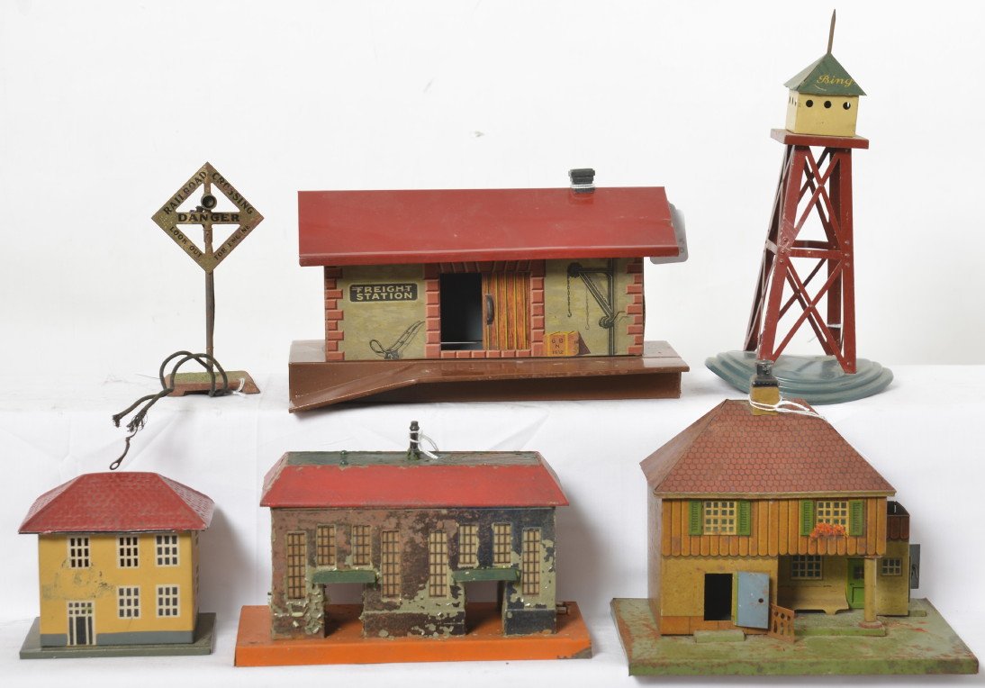 Large group of Bing stations, tower, more: Prewar Bing O/standard gauge passenger and freight stations, airplane/blimp/dirigible tower/mooring mast, and an unmarked crossing signal with textured base. Some repainting, some rust, some flaking p