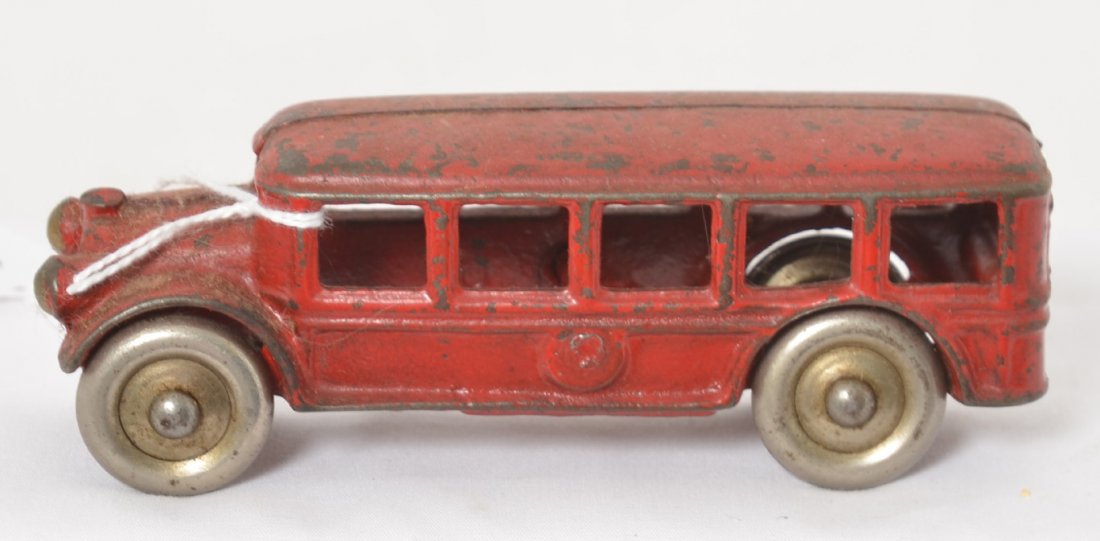 Cast iron touring/passenger bus w/steel wheels: Cast iron touring/passenger bus with steel wheels, approximately 5 inches long. Appears to be in original paint. Unmarked.