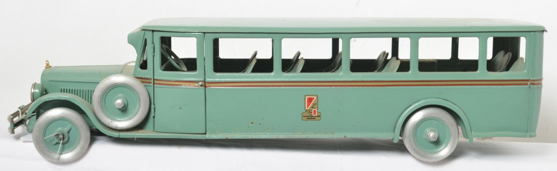 Buddy L Transportation Company touring bus 29î: Pressed steel Buddy L Transportation Company bus, 29 inches long. Missing one hubcap. Older restoration.