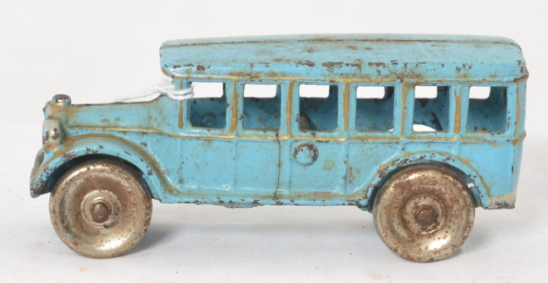 Arcade 312 cast iron bus 4-3/4 long: Cast iron Arcade 312 bus, 4-3/4 inches long with solid steel wheels. Bus has a crack in one side. Truck appears to be in original paint.