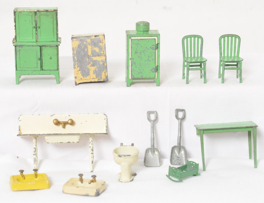 Group of Tootsietoy doll house furniture, kitchen: Group of diecast Tootsietoy doll house furniture for the kitchen, dining room, bathroom, and childÍs room. Cupboard, toilet, lavatory sinks, kitchen sink, refrigerators, chairs, table, crib/rocking b