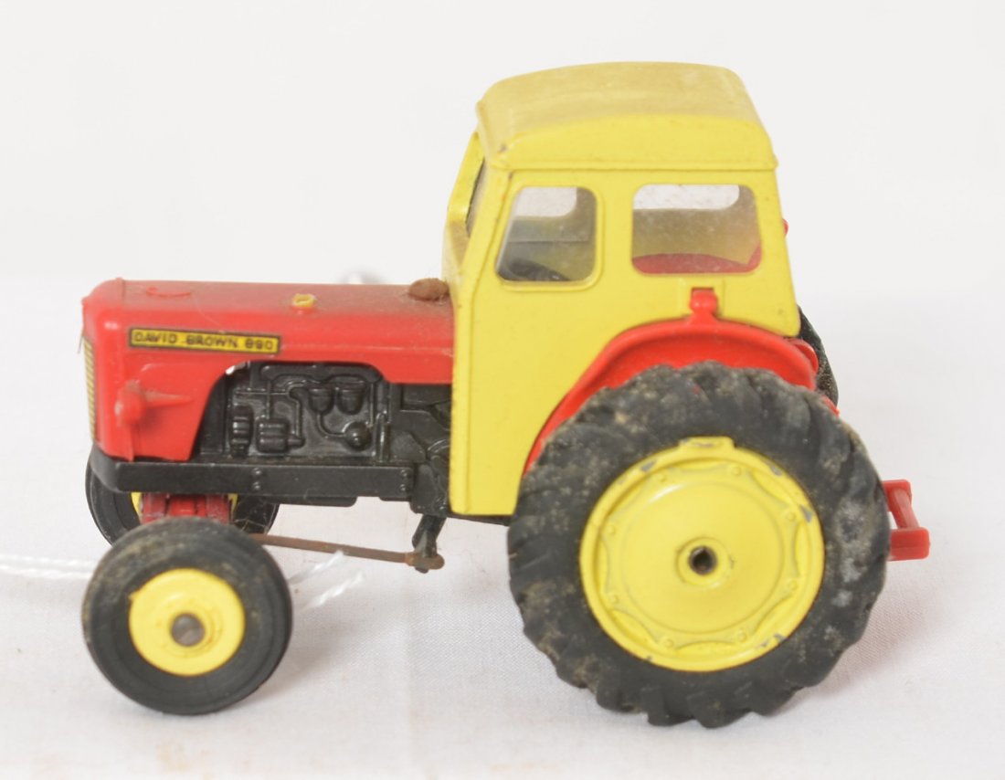 Dinky Toys David Brown 890 tractor with cab: Dinky Toys diecast David Brown 890 farm tractor with cab, oxidation on rubber tires. Toy appears to be in original condition. Measures approximately 82mm long.