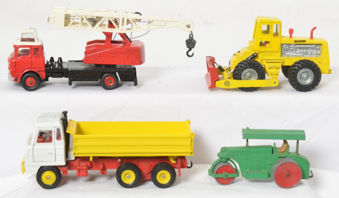 Four Dinky Toys diecast construction vehicles 970,: Four Dinky Toys diecast construction toy vehicles. Aveling Barford roller, 970 Jones Fleetmaster crane truck, 976 Michigan Tractor Dozer 180-111, and Foden dump truck. All appear to be in original con