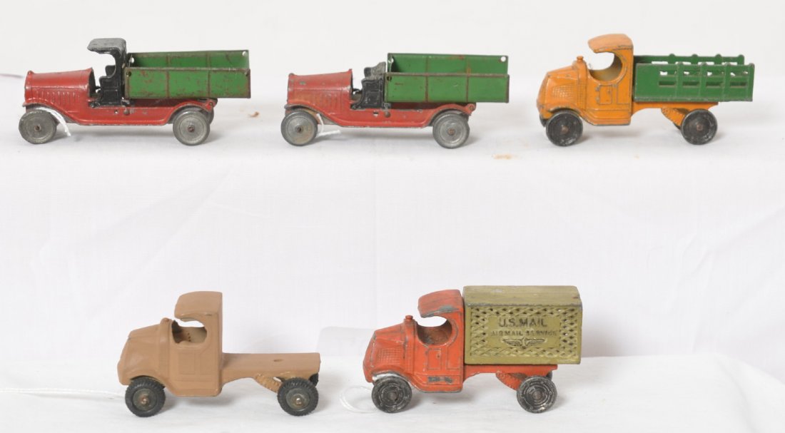 Five Tootsietoy Mack and other diecast toy trucks,: Five Tootsietoy Mack US Mail Airmail Service truck, Mack semi tractor truck, Mack truck with stake sides, and two dump trucks. One dump truck has missing roof and oxidation, semi tractor looks repaint