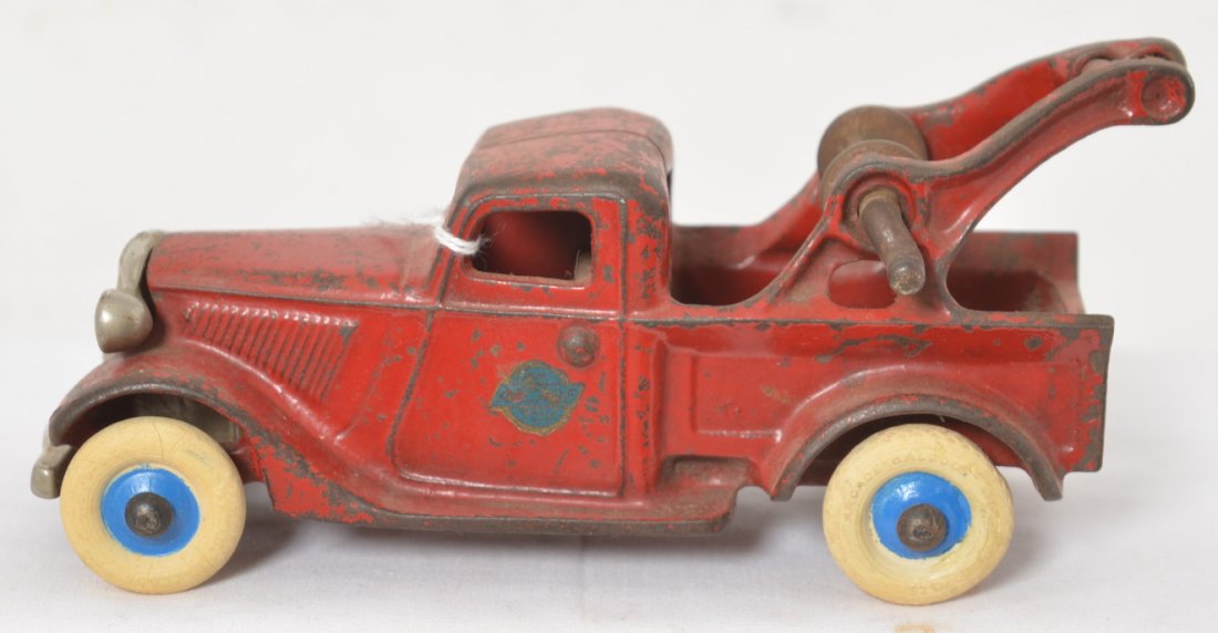 Arcade cast iron tow truck in original paint 202? 7: Arcade 202? cast iron tow truck in original condition with original paint, decal, balloon tires, and parts. Truck measures approximately 7 inches long.