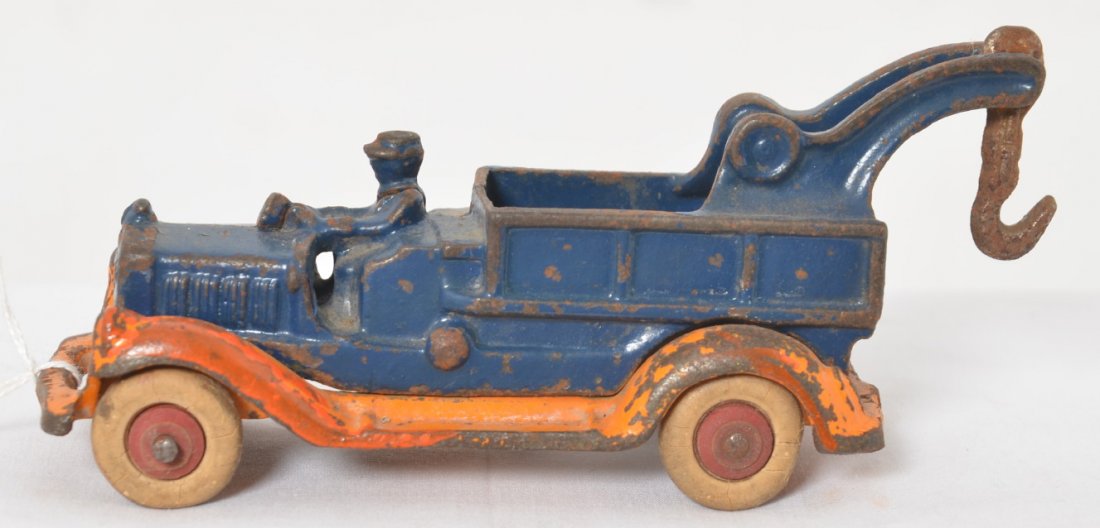 Cast iron Take-Apart tow truck 6.25 long A.C. Williams: Early cast iron toy, Take-Apart tow truck with driver approximately 6-1/4 inches long. Truck has some orange paint on one side around fenders. Truck otherwise is in original condition. A.C. Williams, 
