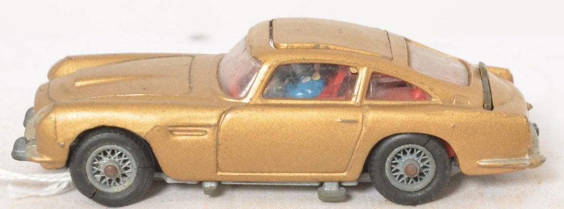 Corgi Toys James Bond Aston Martin DB5 diecast car: Corgi Toys James Bond Aston Martin DB5 diecast car in original paint with original tires. Tires have some flats and splits. Car appears to be complete with all parts.