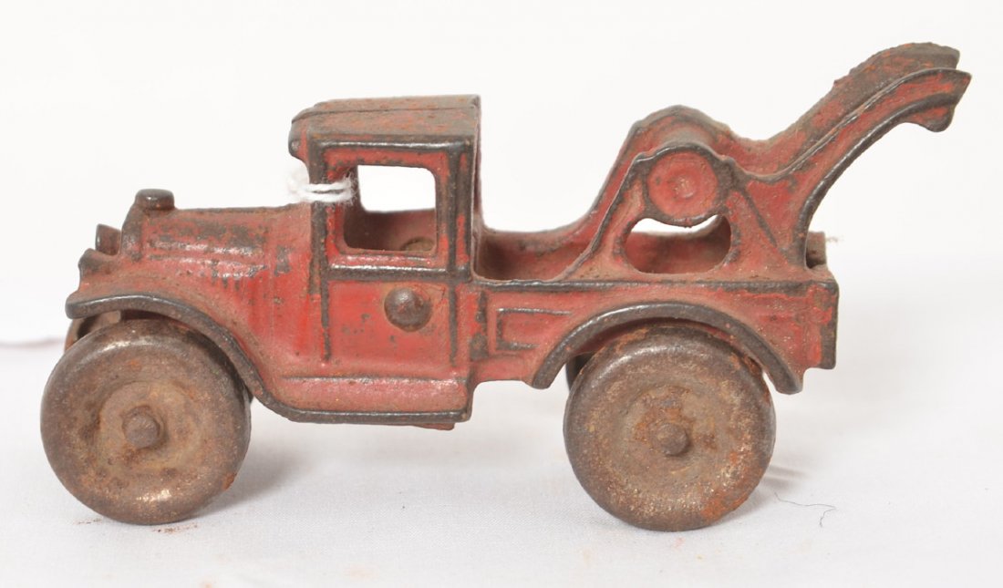 Early cast iron tow truck, solid nickel wheels: Early cast iron tow truck, solid nickel wheels measuring approximately 4-5/8 inches long. Paint appears to be original.