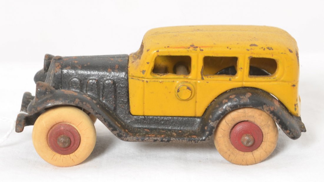 Cast iron Take-Apart sedan with rubber tires 4 inches: Cast iron Take-Apart sedan in original paint and tires with piano, approximately 4 inches long.