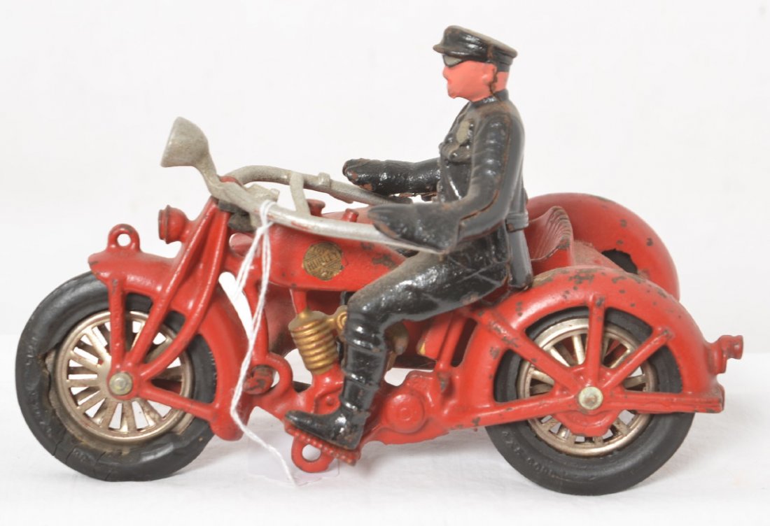 Hubley cast iron Indian/H.D. motorcycle with side car: Hubley cast iron Indian/Harley Davidson motorcycle with driver and side car. No armor shield, no rider. Tires have flats and splits. Appears to be in original paint. Decal appears to be original.