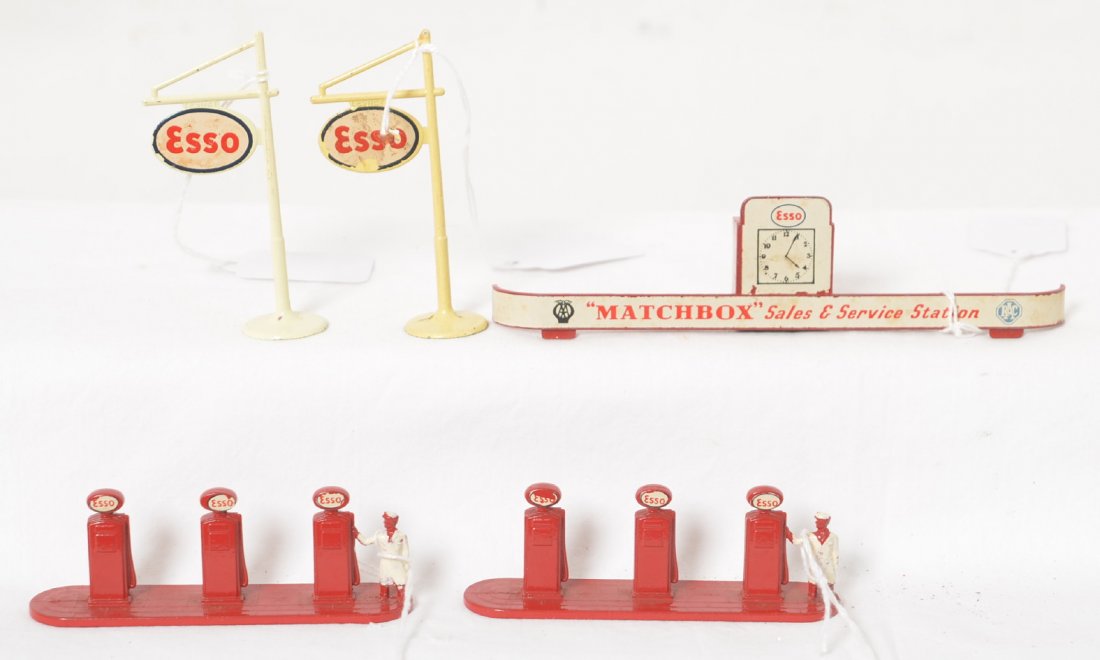 Matchbox Esso gas pump islands, signs, banner: Two diecast Matchbox Lesney Esso gas pump islands with attendants and two signs. Tiny bit of chipping to decals only on pump islands. No wear to paint on pump islands. Signs have some chipping to deca