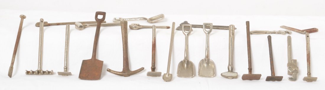 Arcade/Hubley nickel plated tools childÍs toys: Arcade/Hubley nickel plated cast iron hand tools childÍs toys. Shovel, pry bar, square, hatchet, sledge hammer, crescent wrench, hoe, garden rake, pipe wrench, pick ax. Some varying rust. 21 pieces.