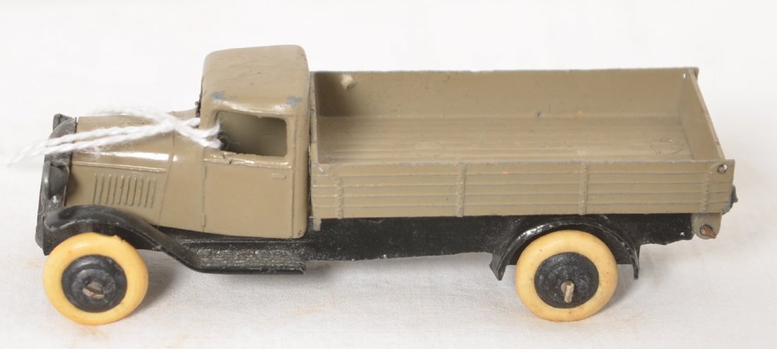 Diecast lead Dinky Toys truck w/long dump bed w/gate: Diecast lead Dinky Toys truck with long dump bed with swinging gate, original paint and tires. One tire has flat.