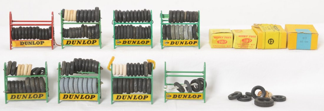 Eight Dinky Toys tire racks, two 787 lighting kits in: Eight Dinky Toys diecast tire racks with tires. 083 and 095 empty boxes. Two 787 lighting kits in original boxes, one factory taped shut.