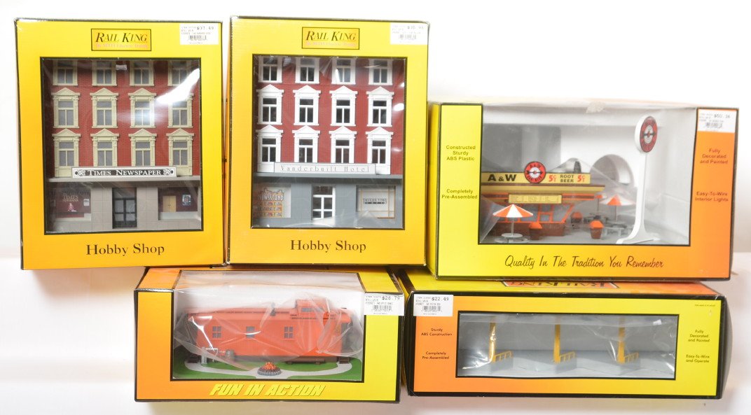 5 Railking buildings hotel, yard office, bus stop, etc: MTH Railking modern O gauge buildings in OBs. Five buildings include 9082 Hotel building, 90014 yard office, 9068 A&W Rootbeer stand, 90078 Times Newspaper building, and 9071 bus stop. Buildings are C