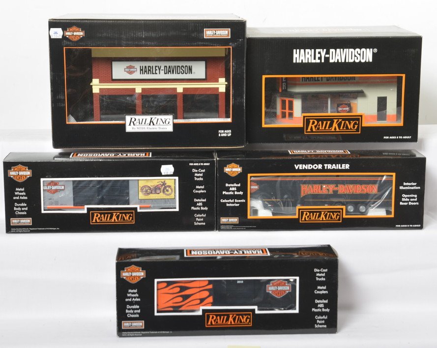 Railking Harley Davidson buildings and freight cars: MTH Railking modern O gauge Harley Davidson building and freight cars in OBs. Includes 90266 store with blinking sign, 90111 dealership, 74600 boxcar, 74472 boxcar, and 50039 vendor trailer. Items are