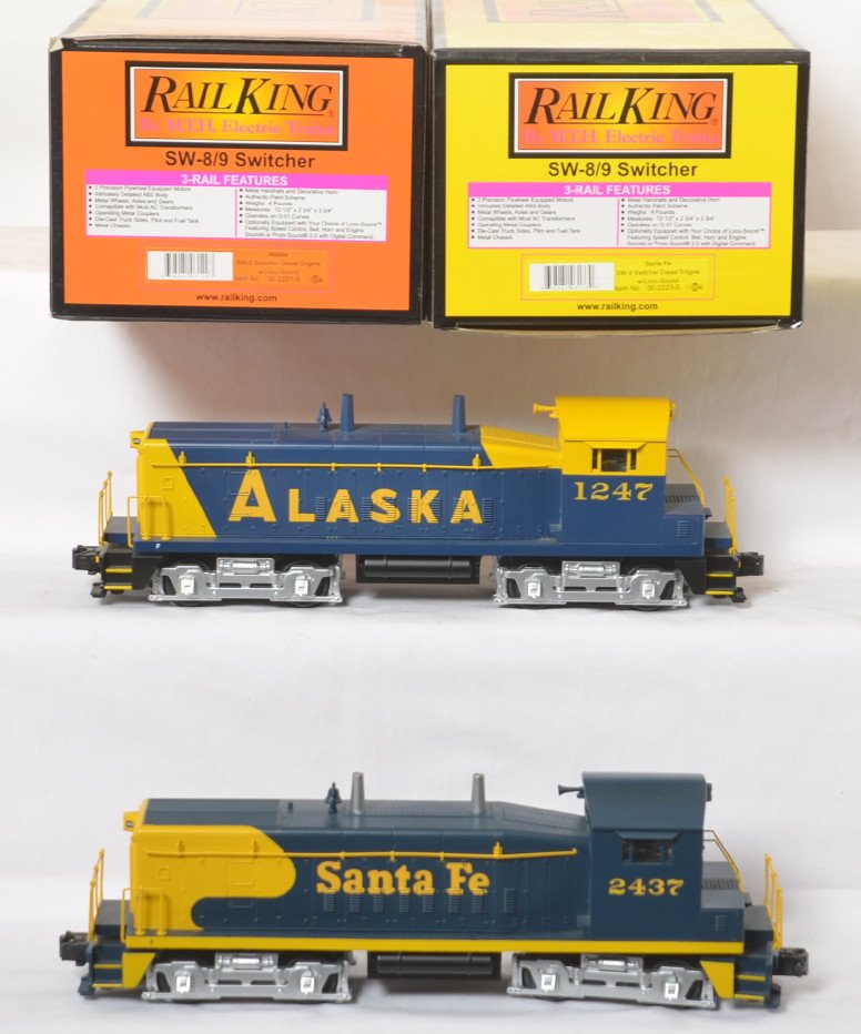 Railking Alaska SW-9 and Santa Fe SW-9: MTH Railking modern O gauge SW-9 diesel locomotives in OBs. Includes 30-2221-0 Alaska and 30-2223-0. Both locos feature Locosounds. OBs have some light corner wear and dust. Locos are C8 to C8+ with l