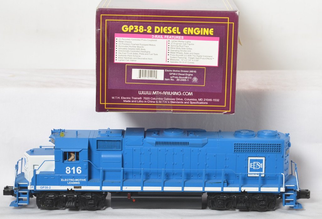 MTH EMD GP38-2 demo with Proto 2: MTH modern O gauge 20-2405-1 EMD Demonstrator GP38-2 diesel locomotive in OB. Loco features Protosound 2.0, DCS control, Protosmoke, Protocouplers, and more. Loco is C8 condition with run time.