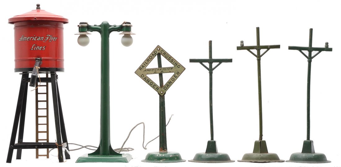 Am Flyer 215 Tower 233 Lamp 206 Sign 209 Poles: American Flyer prewar O gauge accessories including; 215 water tower with black tower, red tank and tan ladder, a 233 green double lamp post, version with a square base, 206 green danger sign and thre