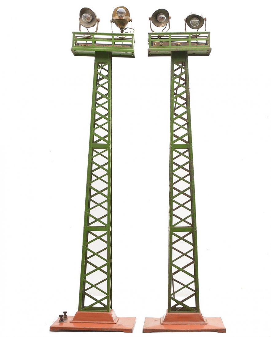 Lionel 2-92 Floodlight Towers w/T.Cotta Bases: Lionel prewar standard gauge two 92 floodlight towers with terra cotta bases, pea green towers and brass plates. One of the floodlight towers is unusual because it is mounted to face the side of the b