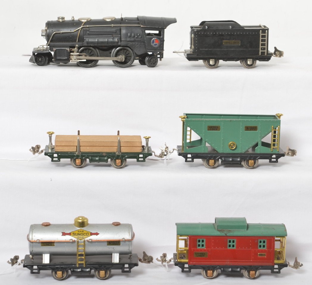 Lionel 259/tender, 831, 804, 803, 807 steam freight: Prewar Lionel O gauge 259 steam locomotive with unnumbered tender, 831 lumber car, 804 Sunoco tank, 804 hopper, and 807 caboose. Tender has nickel journals. Trains have copper journals. Trains look mu