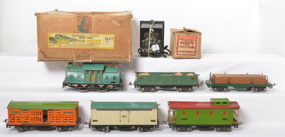 Lionel 354E w/10E, 511, 512, 513, 514, 517 in OB: Prewar Lionel standard gauge boxed 354E outfit with No. 10E in Peacock, 511 lumber car w/load, 512 gondola w/four canisters, 513 cattle car, 514 boxcar, and 517 caboose, C6 trains. Included is a Type