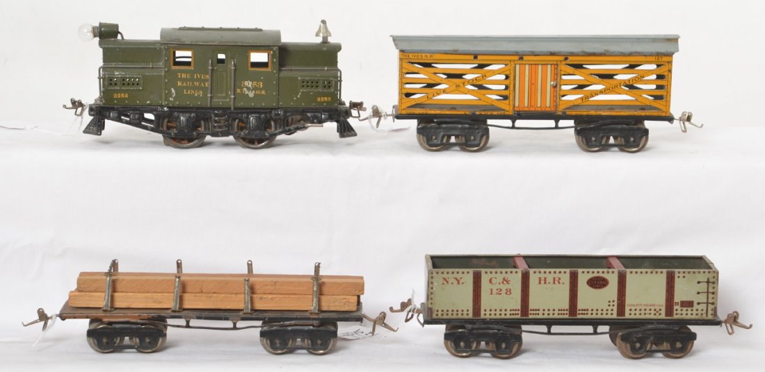 Ives 3253 NYC&HR, flat, 127 livestock, 128 NYC&HR: Prewar Ives O/narrow gauge 3253 NYC&HR center cab electric locomotive with unnumbered flat car with lumber, 127 Live Stock Transportation, and 128 NYC&HR gondola, C6. Flatcar may be very old repaint.
