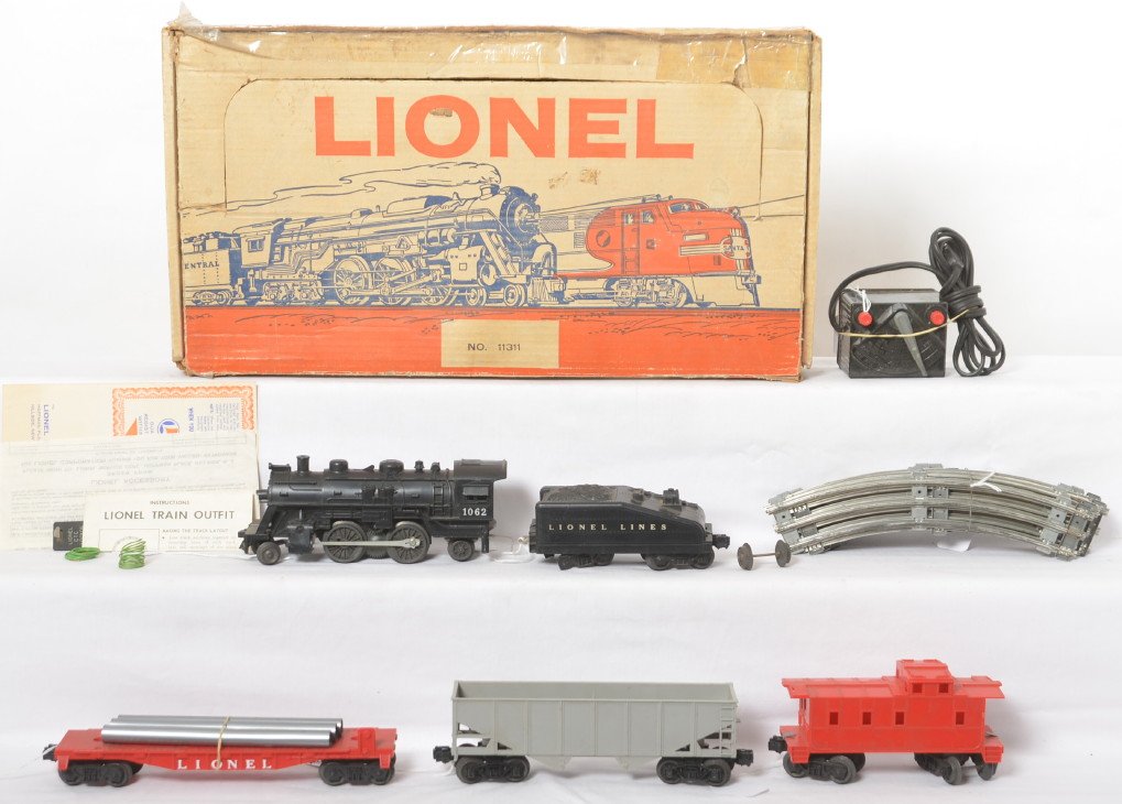 Lionel 11311 steam freight with headlight in OB: Postwar Lionel O gauge 11311 steam freight set with headlight in original box with 1062 steam loco with slopeback tender, undecorated hopper, unnumbered flat, and undecorated caboose, C6-7 area. Bundl